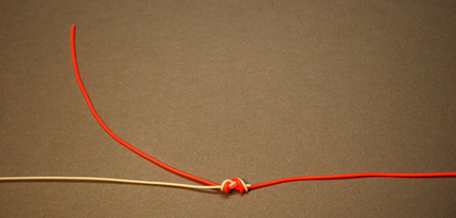 Clip the 5X tippet material tag close to the knot and retain the tag end of the 4X leader (parent material). Tie the dropper fly to the end of the tag.