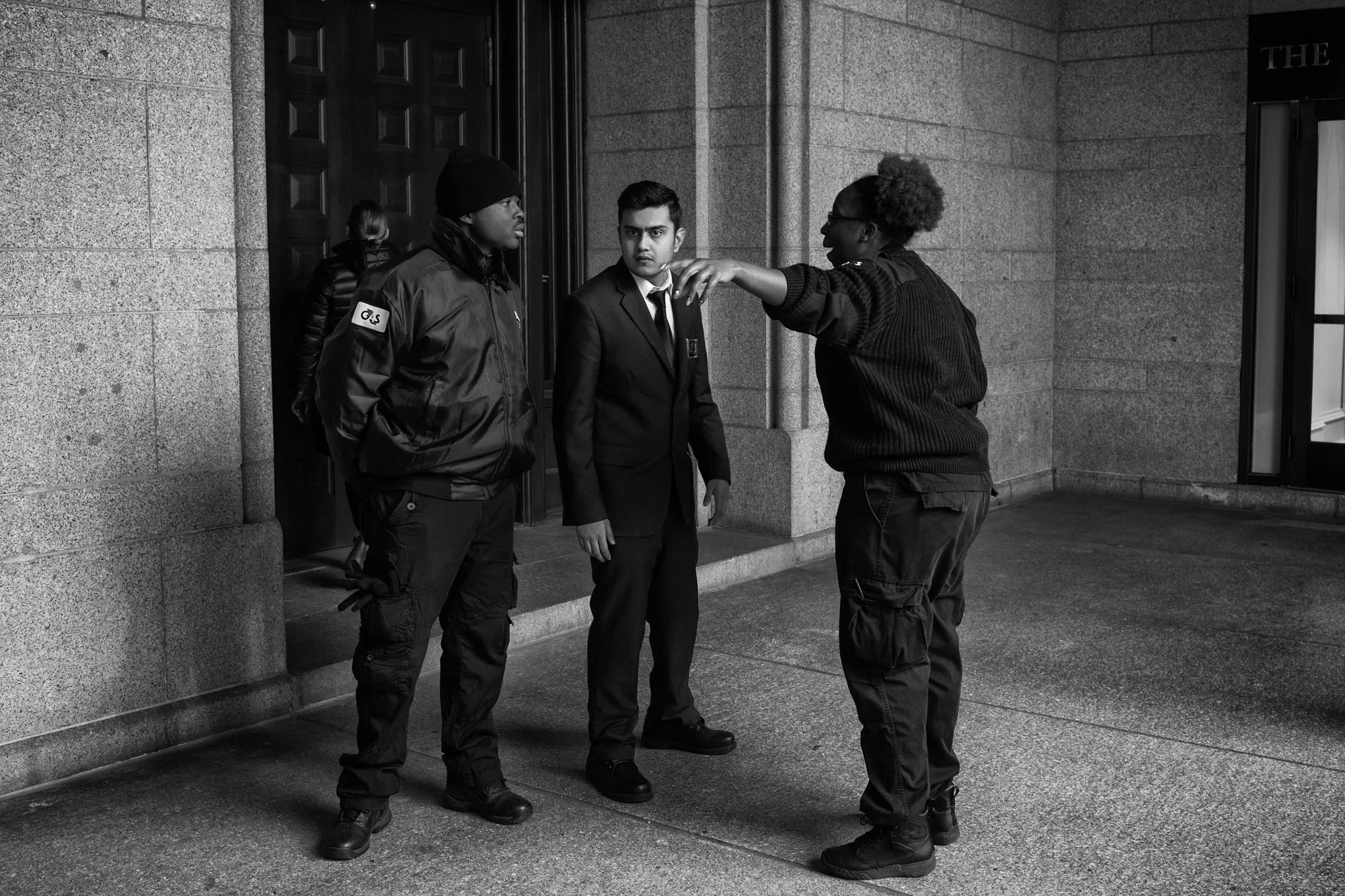 Security guards at the Trump hotel watch protesters after President Trump's executive order banning people from seven countries from entering the United States, on January 29, 2017.
