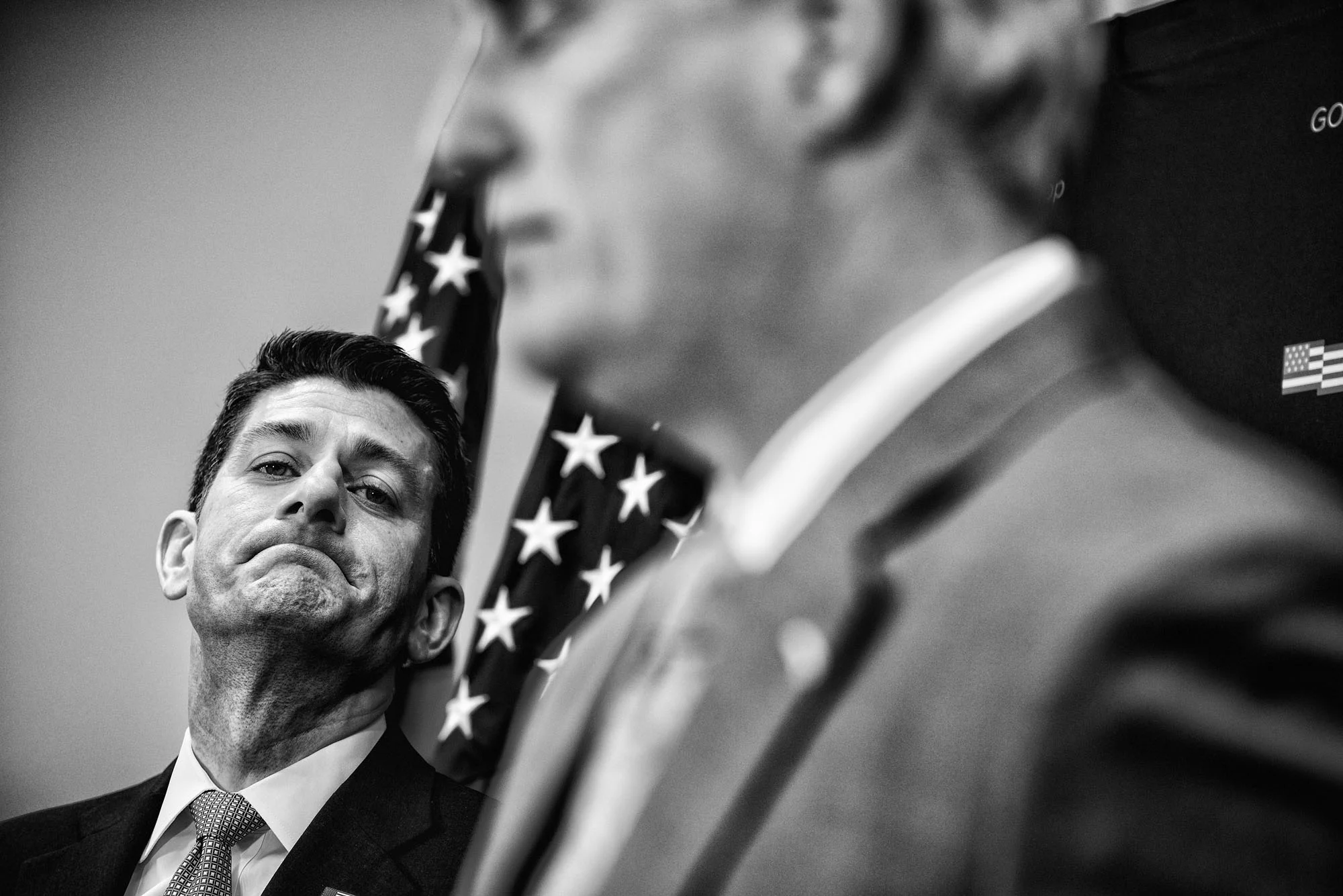 House Speaker Paul Ryan listens to House Majority Leader Kevin McCarthy speak to the media during a briefing after attending a closed House Republican conference on March 28, 2017