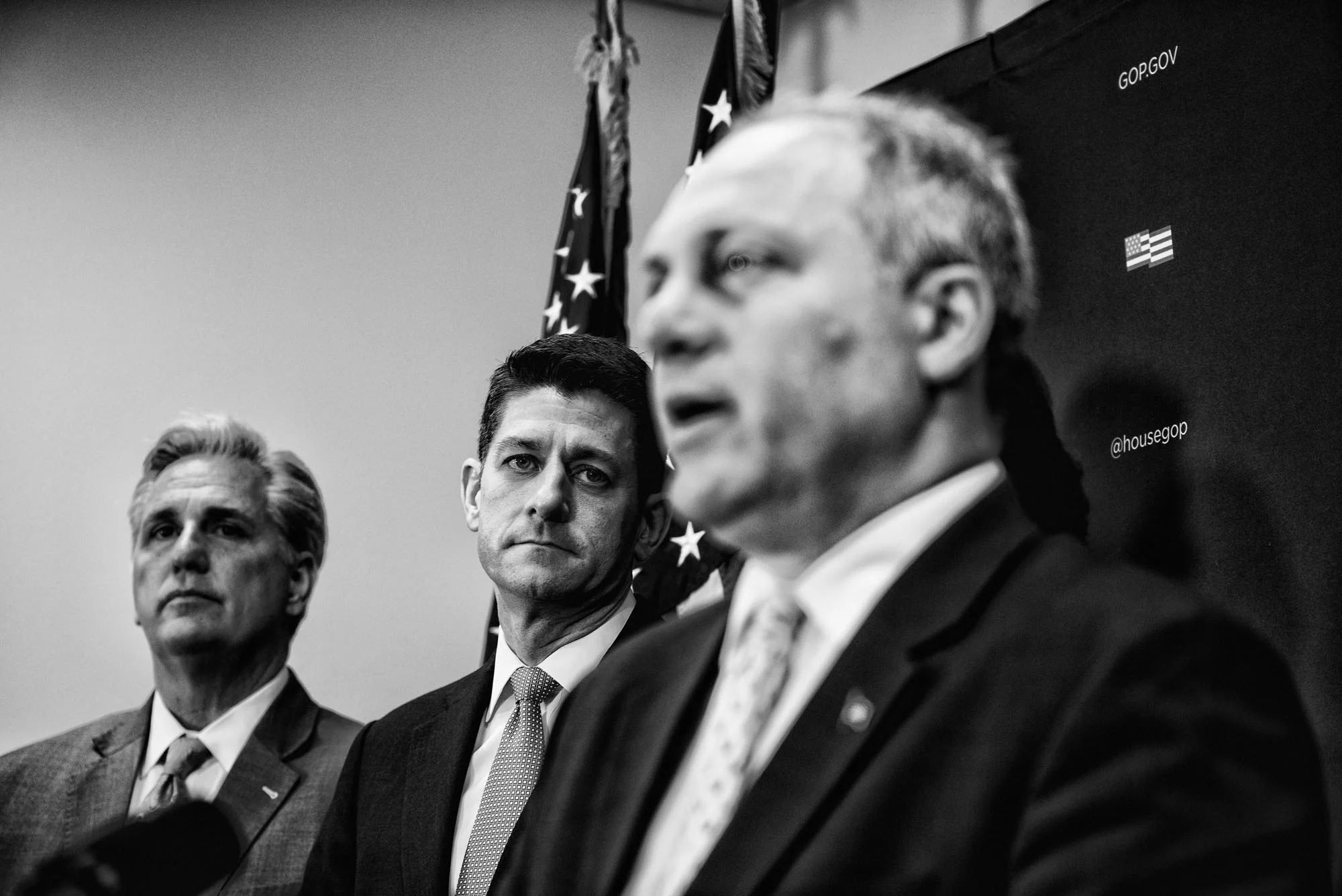 House Speaker Paul Ryan and House Majority Leader Kevin McCarthy listen to House Majority Whip Steve Scalise speak to the media during a briefing after attending a closed House Republican conference on March 28, 2017