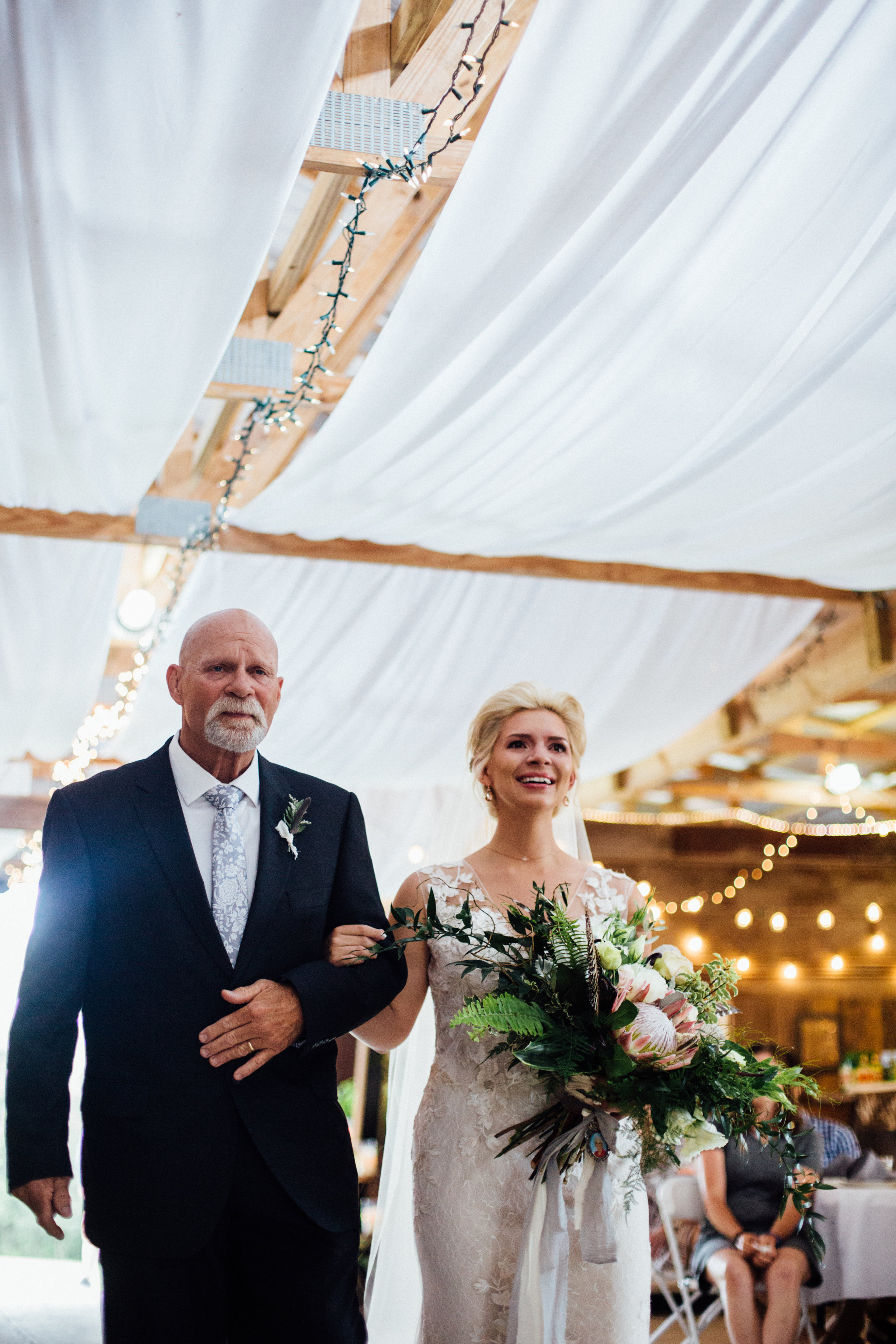 bride walks down the aisle crying