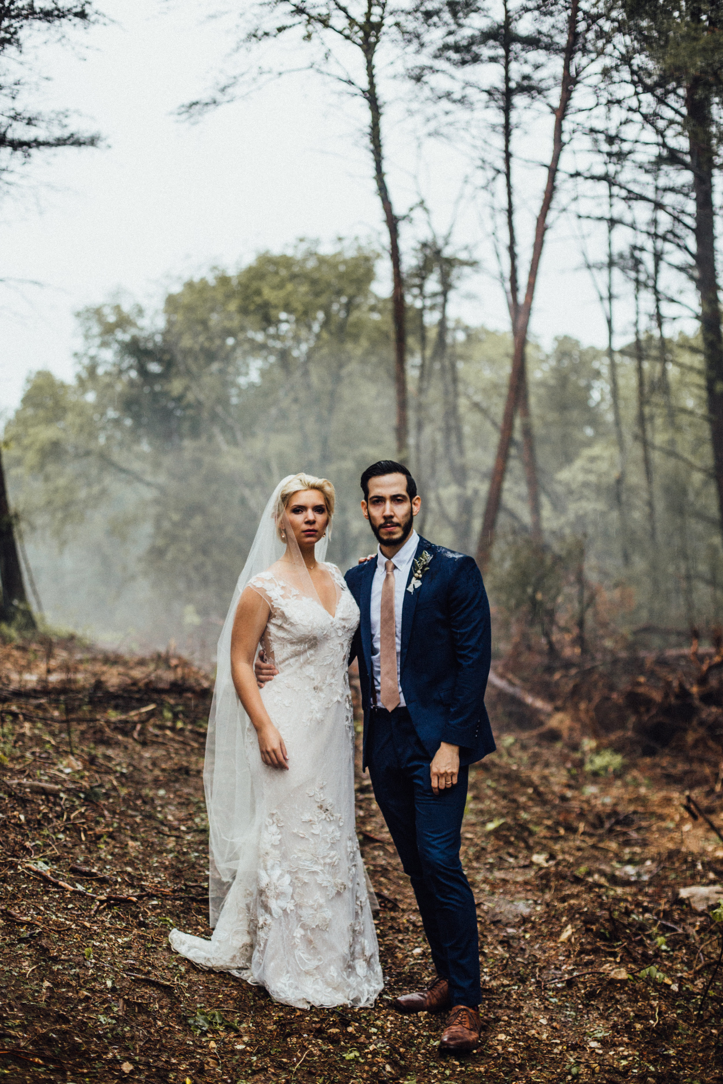 bride and groom serious foggy portrait after rain in the woods