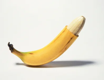 Banana in the peel with the top portion of the peel sliced off to mimic circumcision
