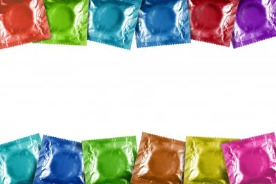 Two rows of condom packages lined up, each in a different color