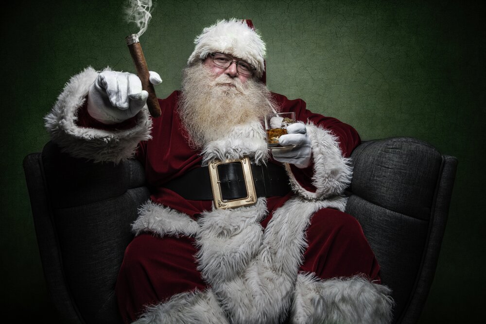 Santa Claus smoking a cigar and drinking whiskey.