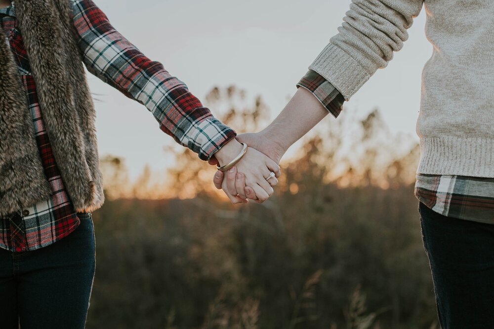 Couple holding hands.