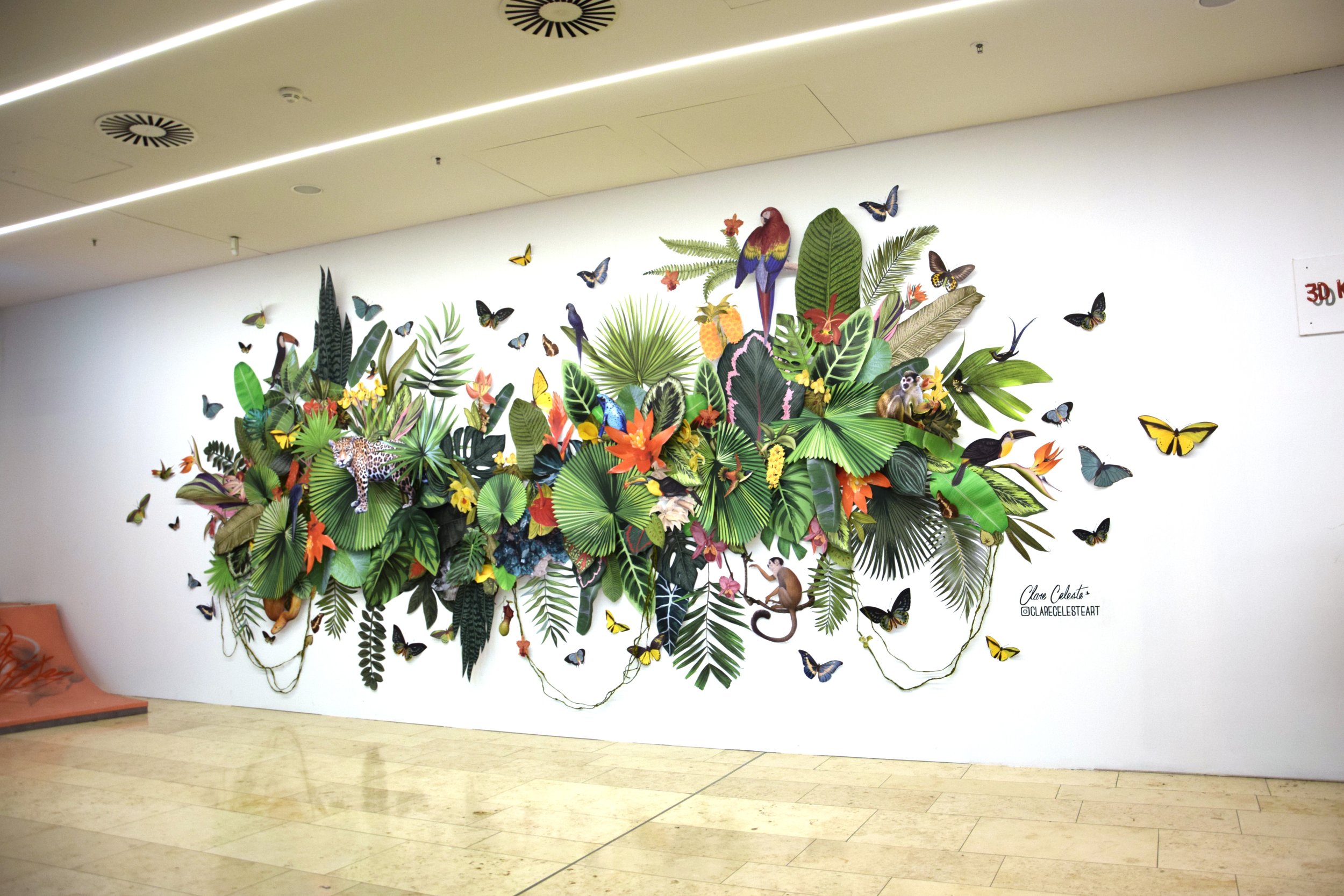 3D mural installation by Clare Celeste Börsch featuring layered botanical collage elements in a public interior space