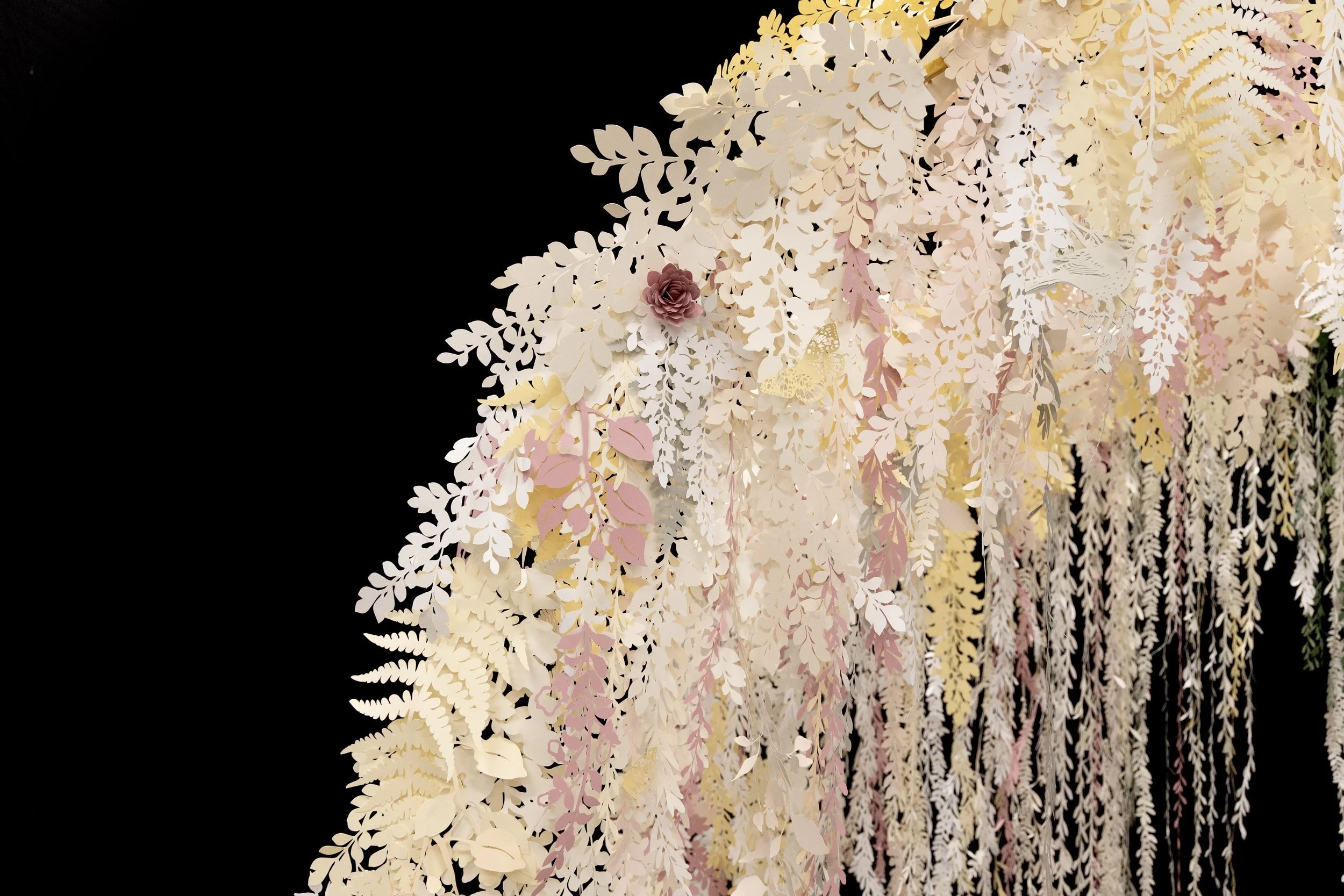 Custom botanical wedding arch by Clare Celeste Börsch, handcrafted from paper and installed as a poetic, nature-inspired ceremony backdrop
