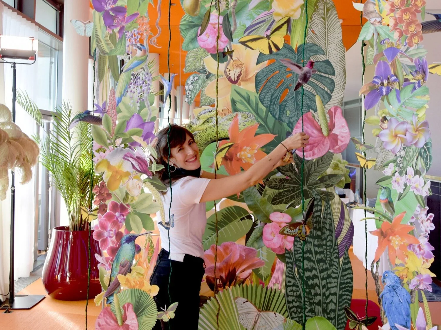Live event art installation by Clare Celeste Börsch created on-site, featuring large-scale botanical collage in progress during a gala or festival