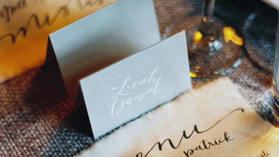  hello, bird. white ink calligraphy on gray // placecards // photo courtesy of Kate Ignatowski Photogra 