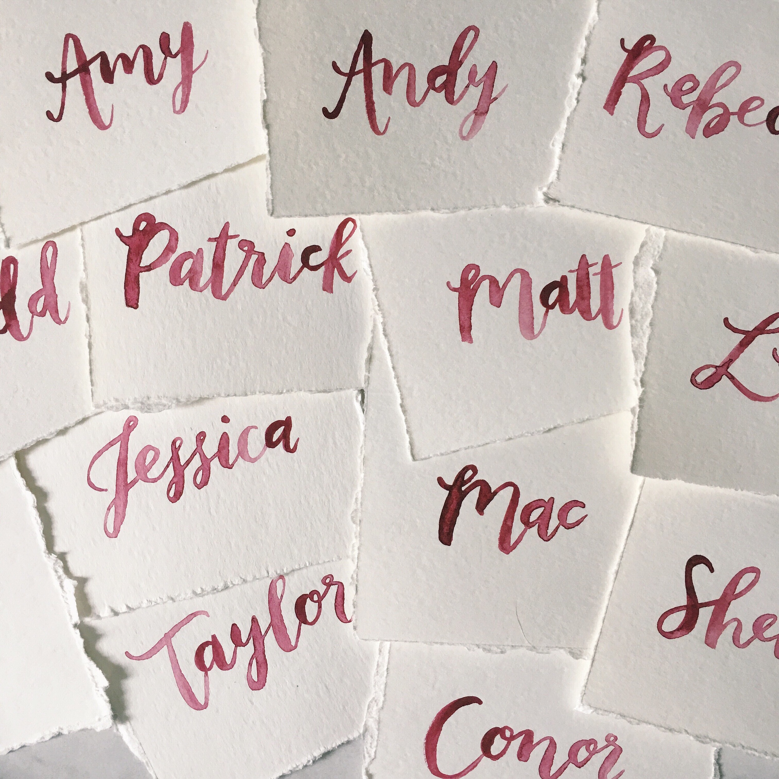  brush calligraphy on white placecards by hello, bird. // raw edges // burgundy oxblood dark red ink 