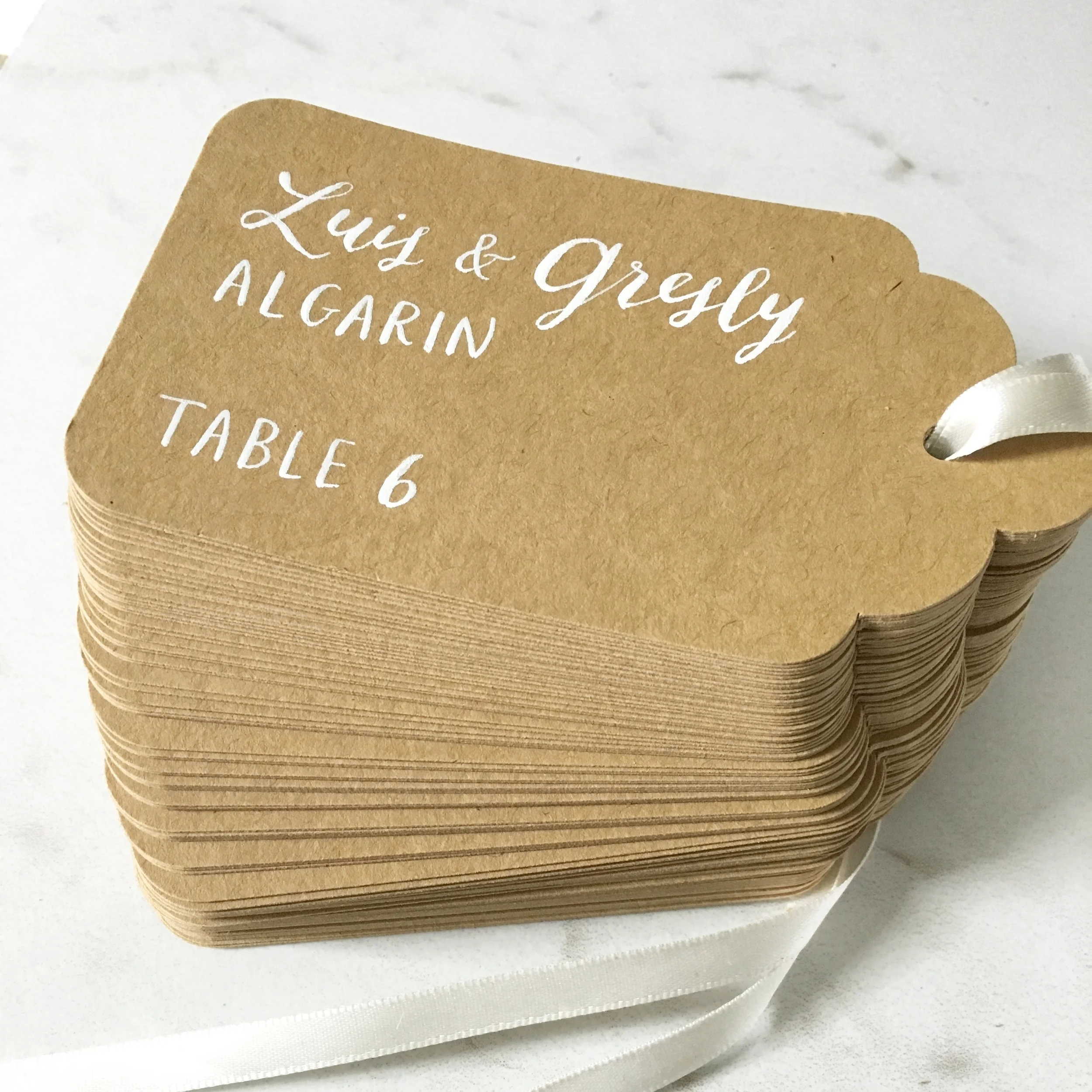  hello, bird. white ink calligraphy on kraft hanging escort cards 