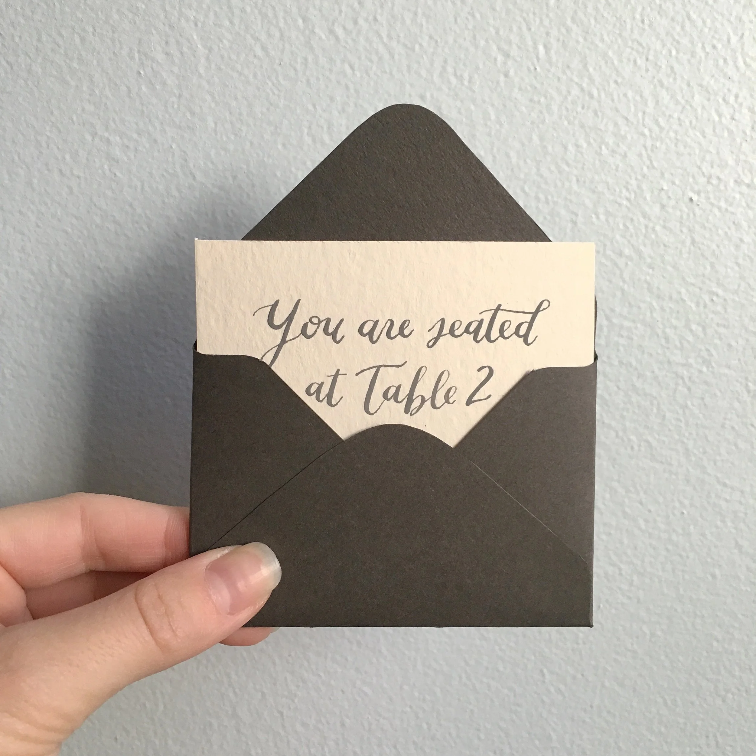  gray ink calligraphy envelope escort cards by hello bird 