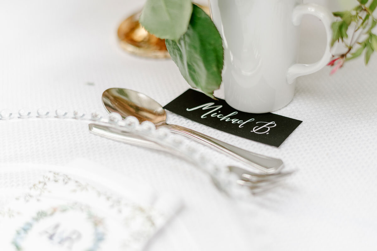 white ink calligraphy place card by hello, bird | photo by Emily Wren Photography