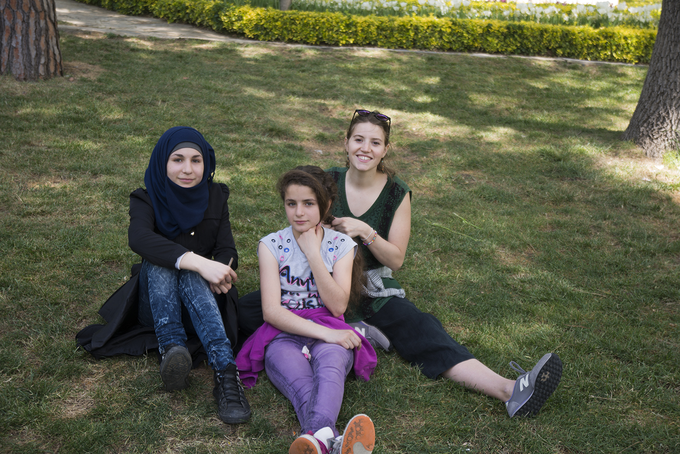 In this photo, Beatrice is sitting with Ravan, age 13 and her younger sister Cuud, age 12. Both of these sweet girls can speak a little English, more than other students in the class. This was Beatrice's last outing with the kids and a nice time to really connect, braid hair, and relax at Emirgan Park.