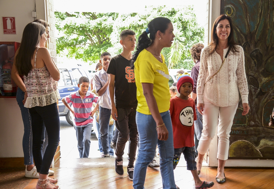 Elizabeth Schummer pictured here with students from her recent photography project in Caracas.