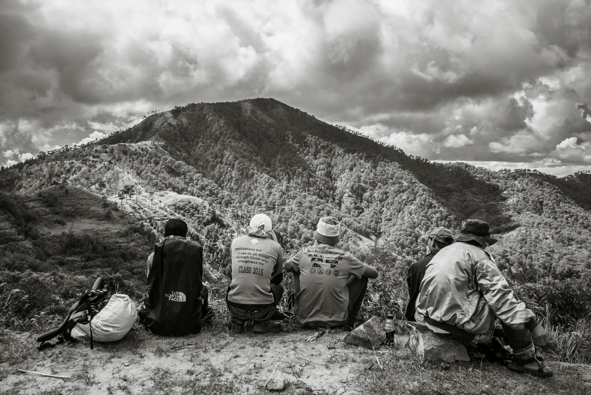 The local guides having a break. Mt. Ugo's summit looms in the background.