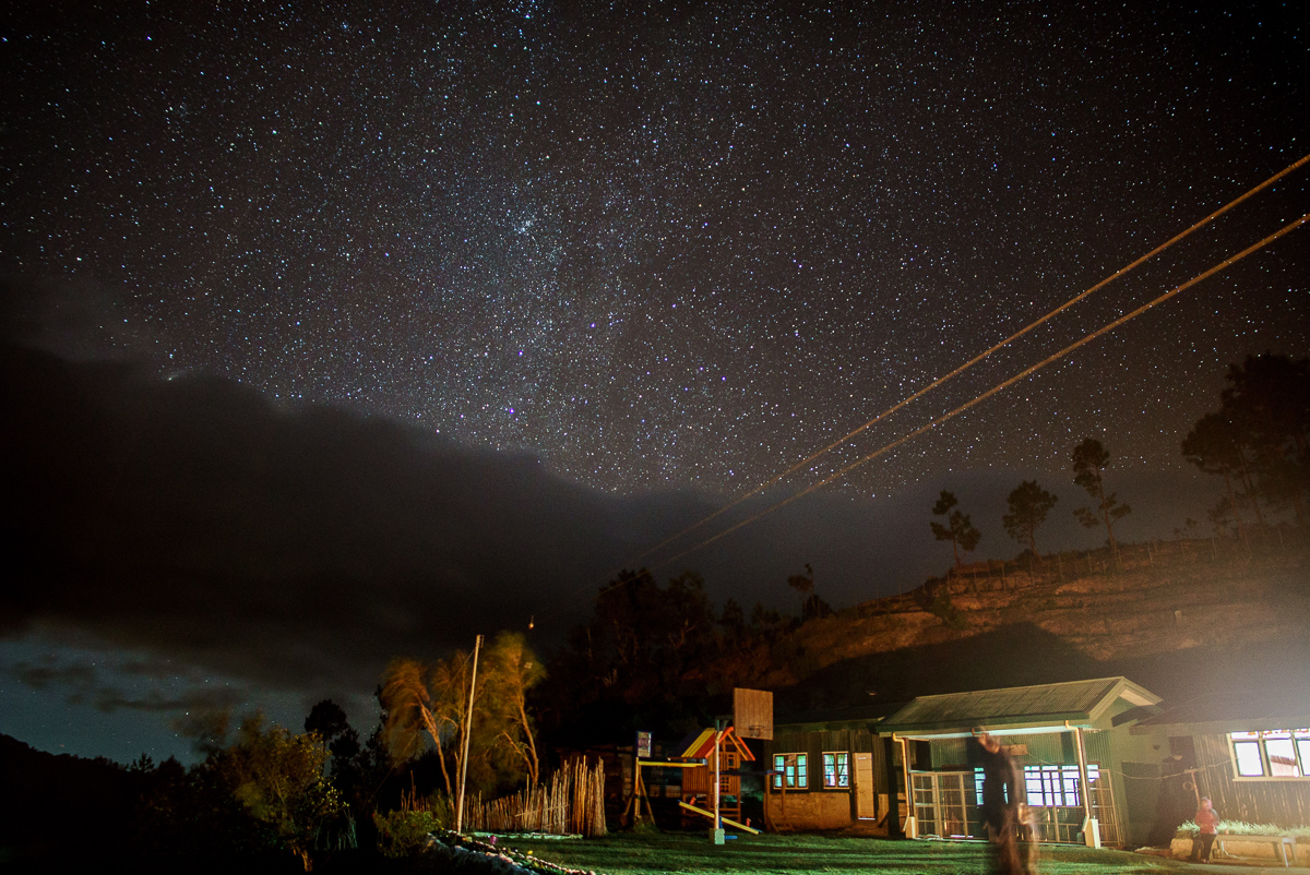 Domolpos Village at night, with the Milky Way vaguely visible behind the clouds.