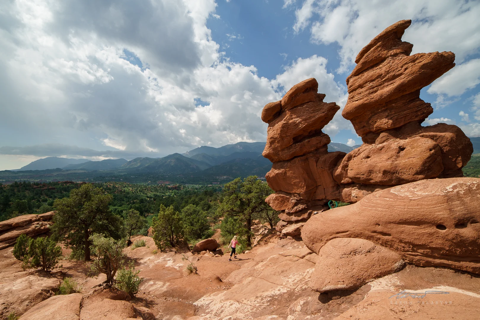 People and nature: a hiker dwarfed by the Siamese Twins. Note the distortion caused by shooting on a 14mm lens.