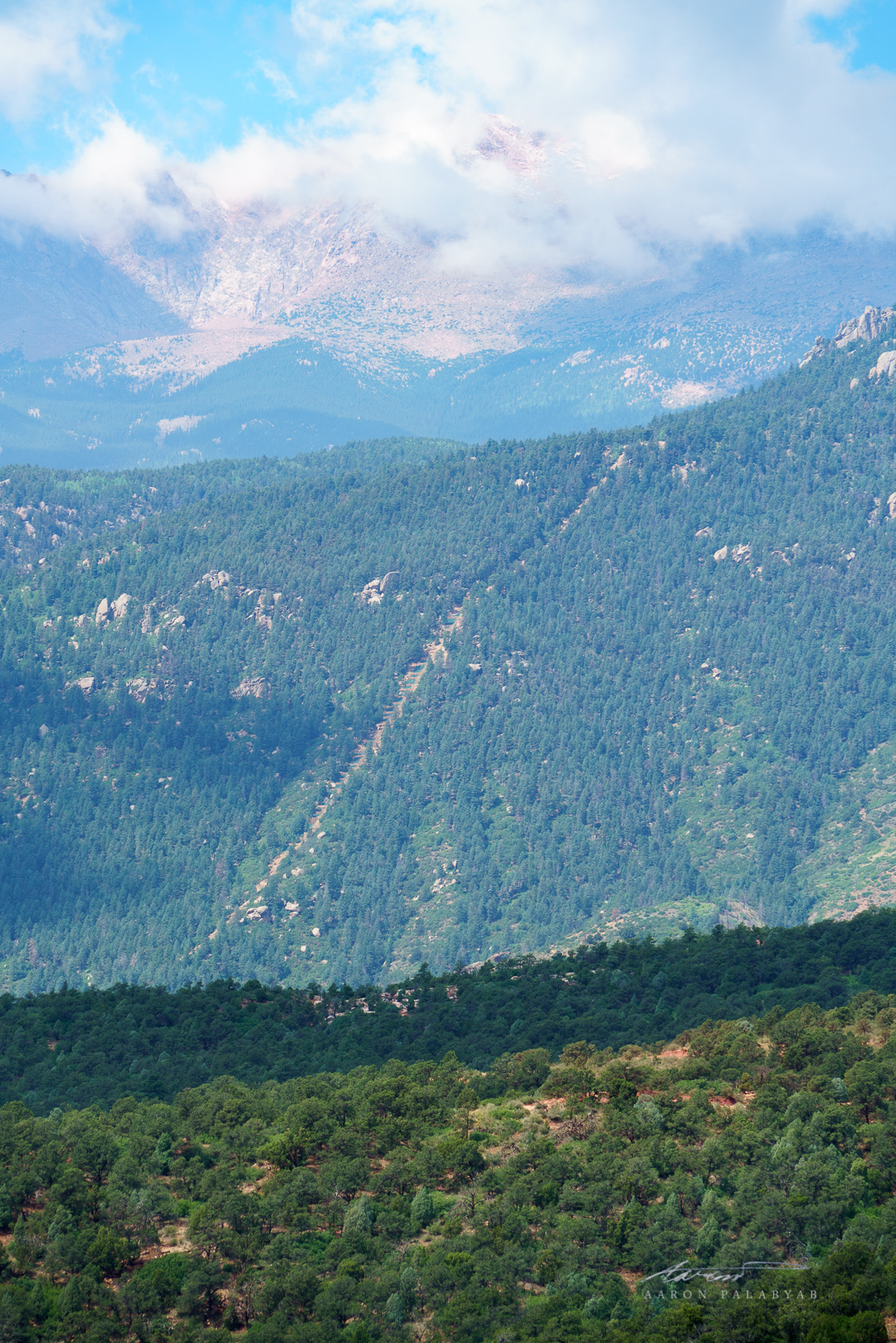 The Manitou Incline as seen from the Garden of the Gods. Behind it, the summit of Pike's Peak glowers from over 14,000 feet high.