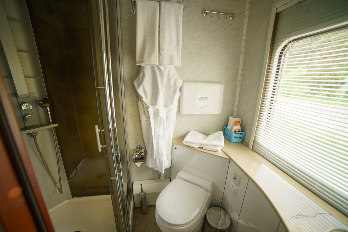 The ensuite bathroom, complete with bathrobes, full-size toiletries, amenity kits, and a heated floor 