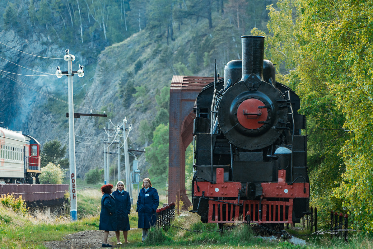 The staff of the GTSE having a conversation by a steam engine on display at this site
