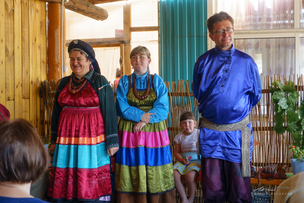 The colorful garb of the Old Believers, and a bored little local girl waiting for her mom