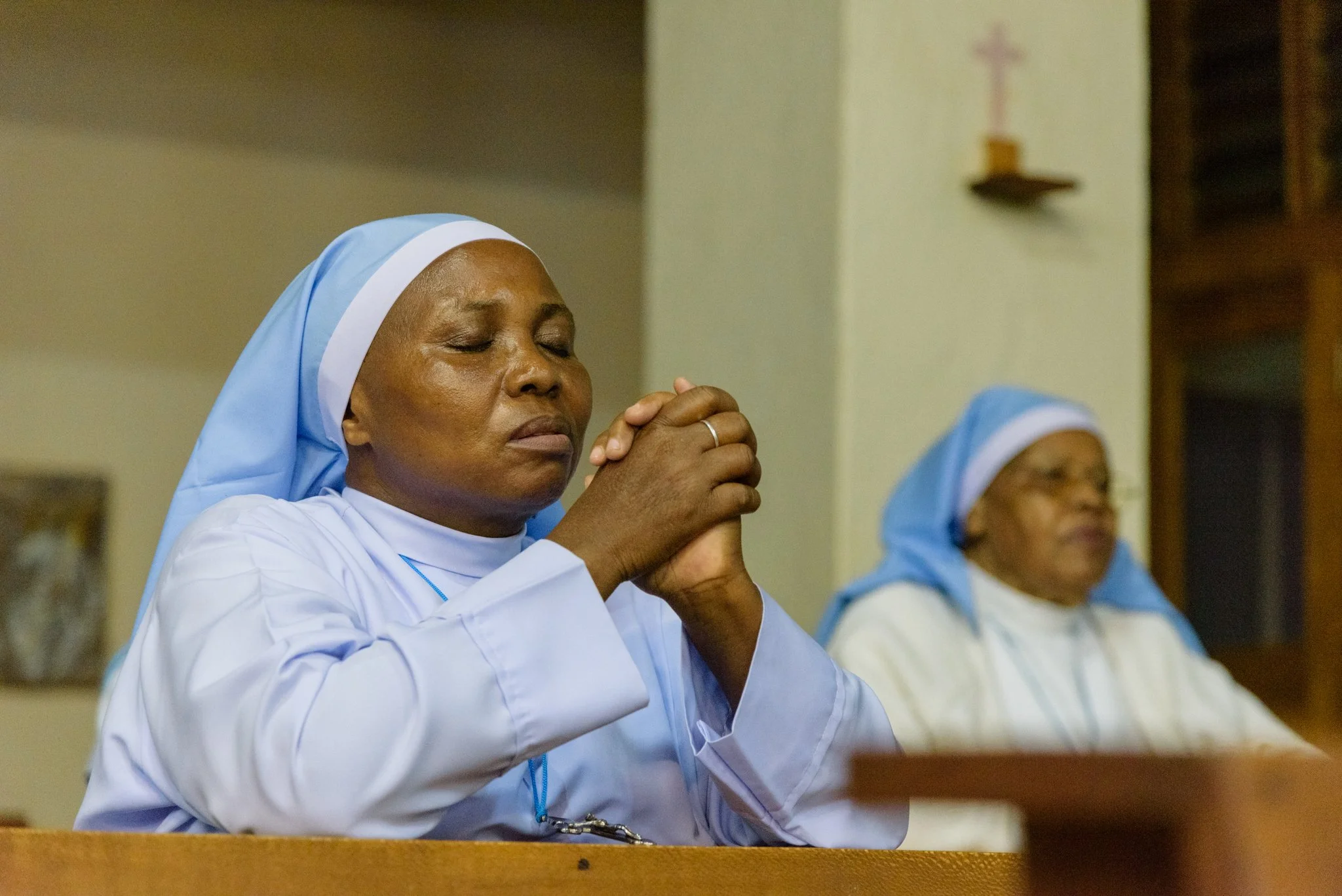Close-up portrait of a Catholic nun praying during a church service at the Usambara Sisters Convent in Korogwe, Tanzania.