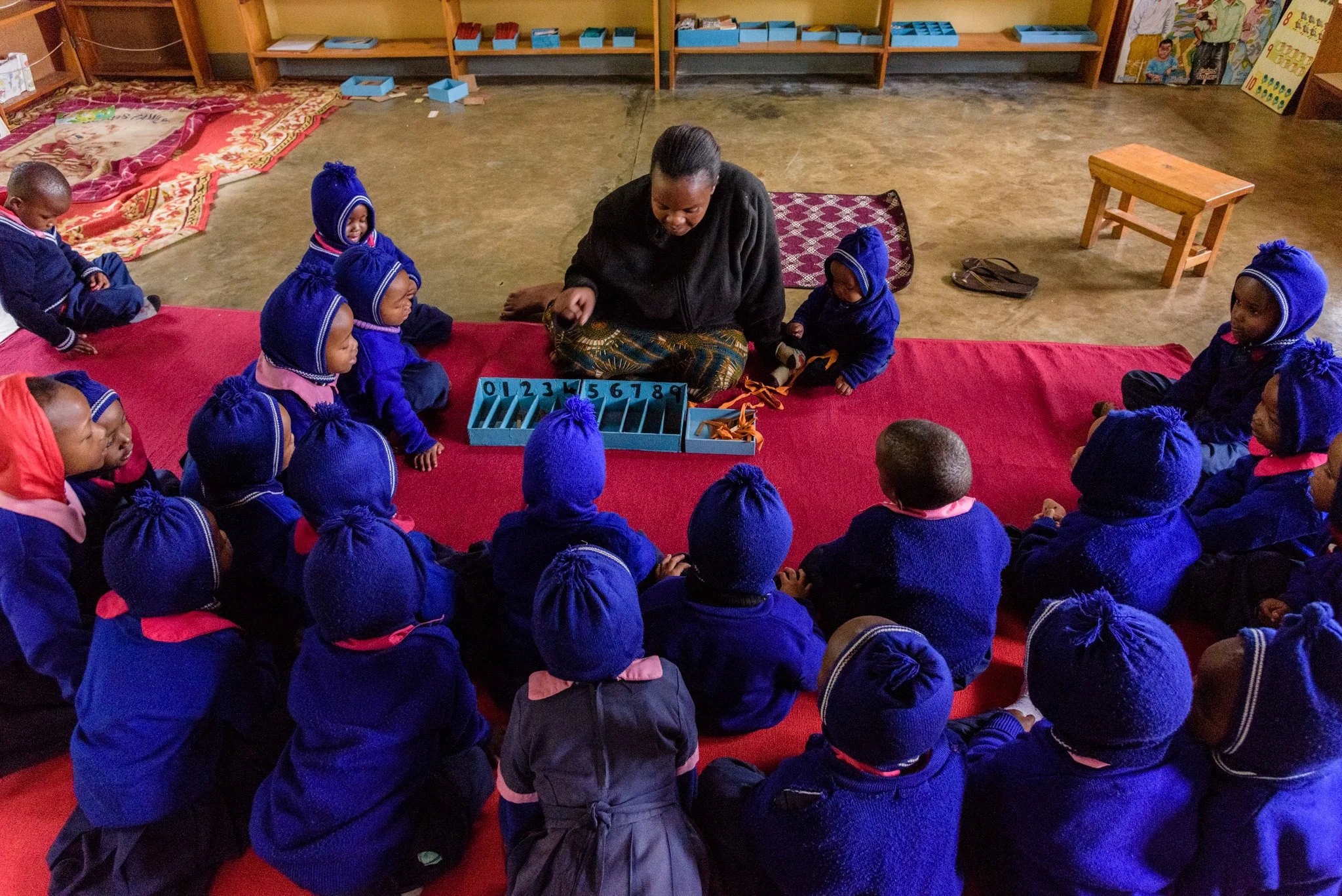 Anatolia Kamote (42), a teacher at Montessori Kindergarten in Lushoto, guiding students through play-based learning using educational tools in Lushoto, Tanga Region, Tanzania.