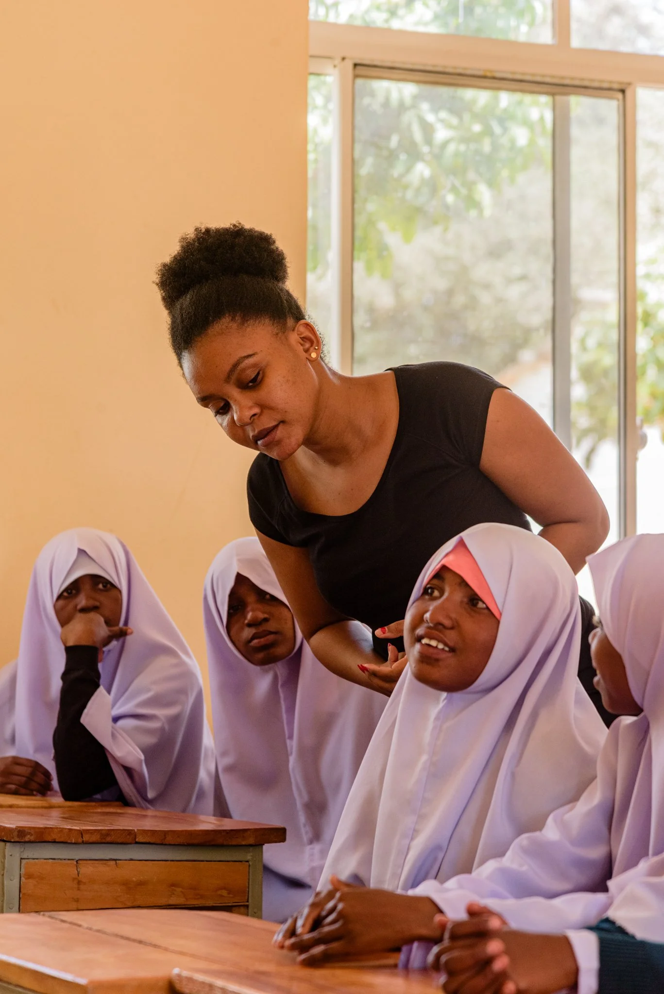 Malala Education Champion interacting with secondary school girls in a classroom in Dodoma, Tanzania.