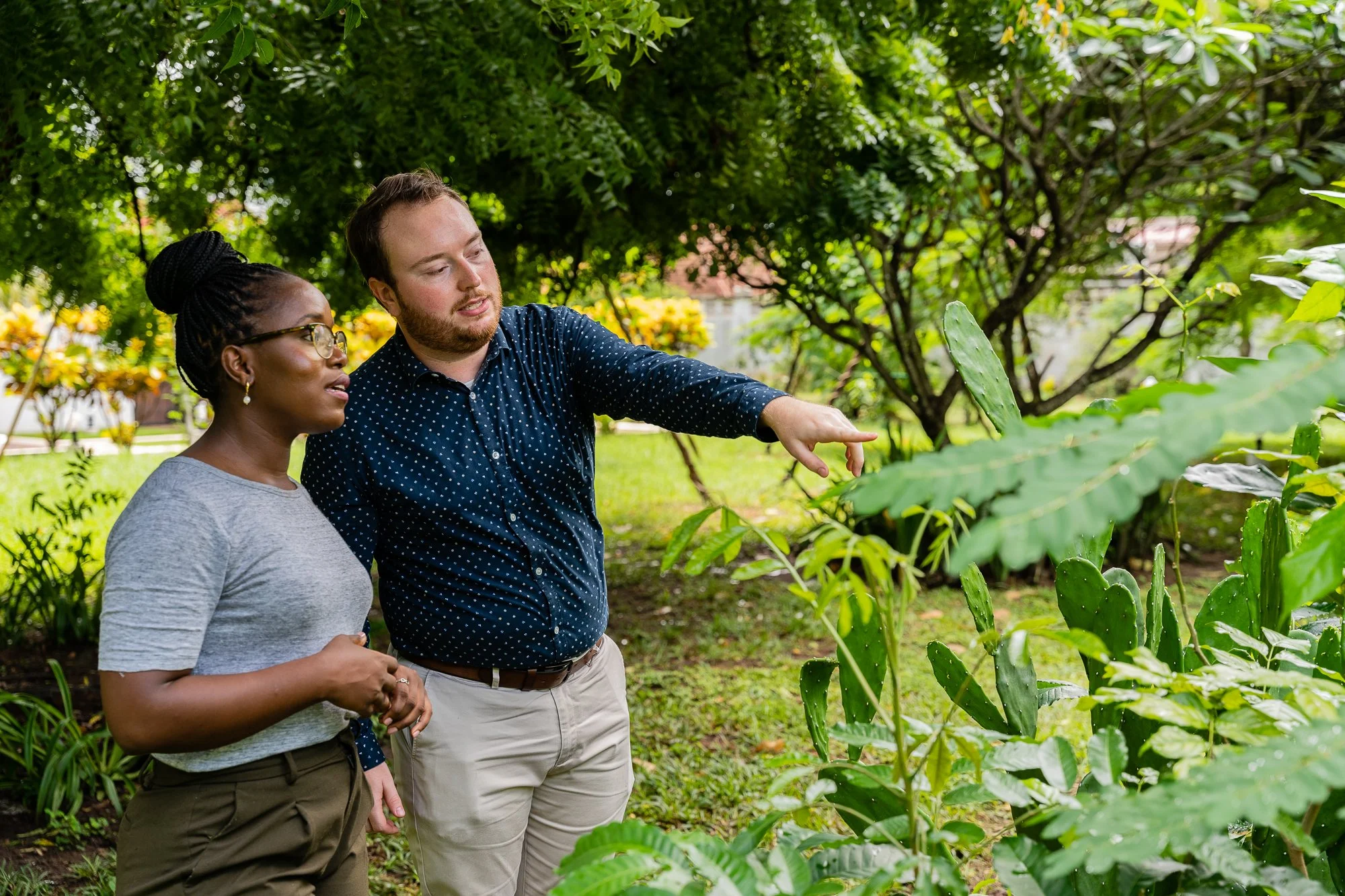 Two AKFC International Youth Fellowship fellows engaged in an outdoor learning discussion in Dar es Salaam, Tanzania.