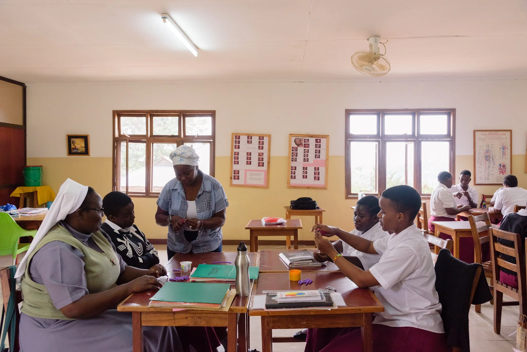 Teacher at the Montessori Training Centre in Mwanza conducting a practical training session with students during a hands-on lesson in Mwanza, Tanzania.