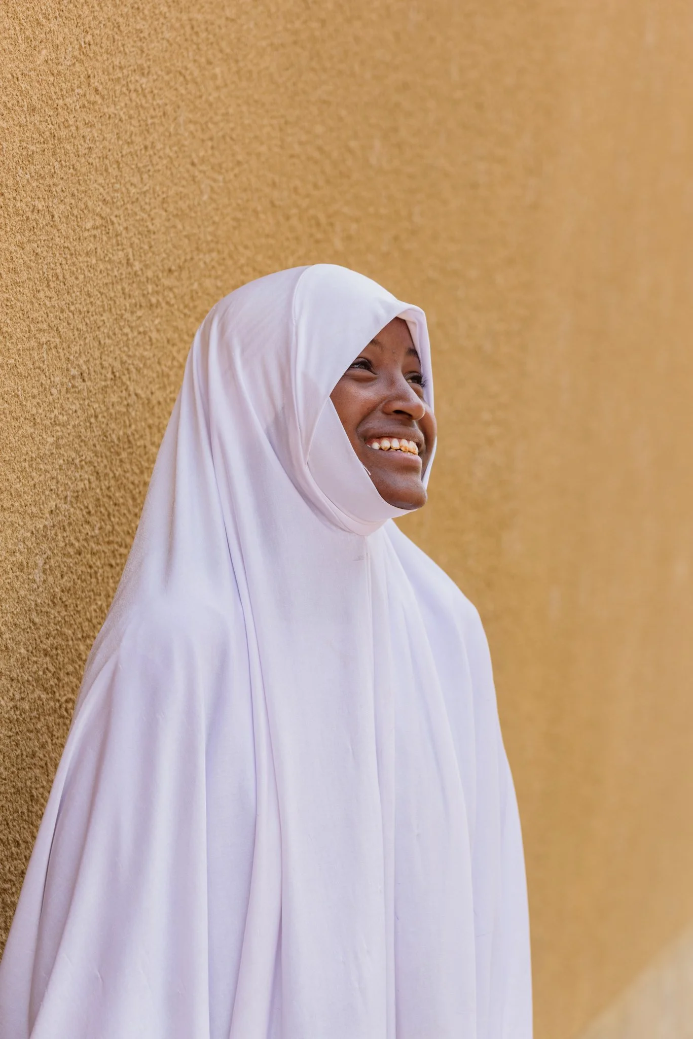 Environmental portrait of a secondary school girl in a white hijab in Arusha, Tanzania, photographed for the Malala Fund as part of a girls’ education project.
