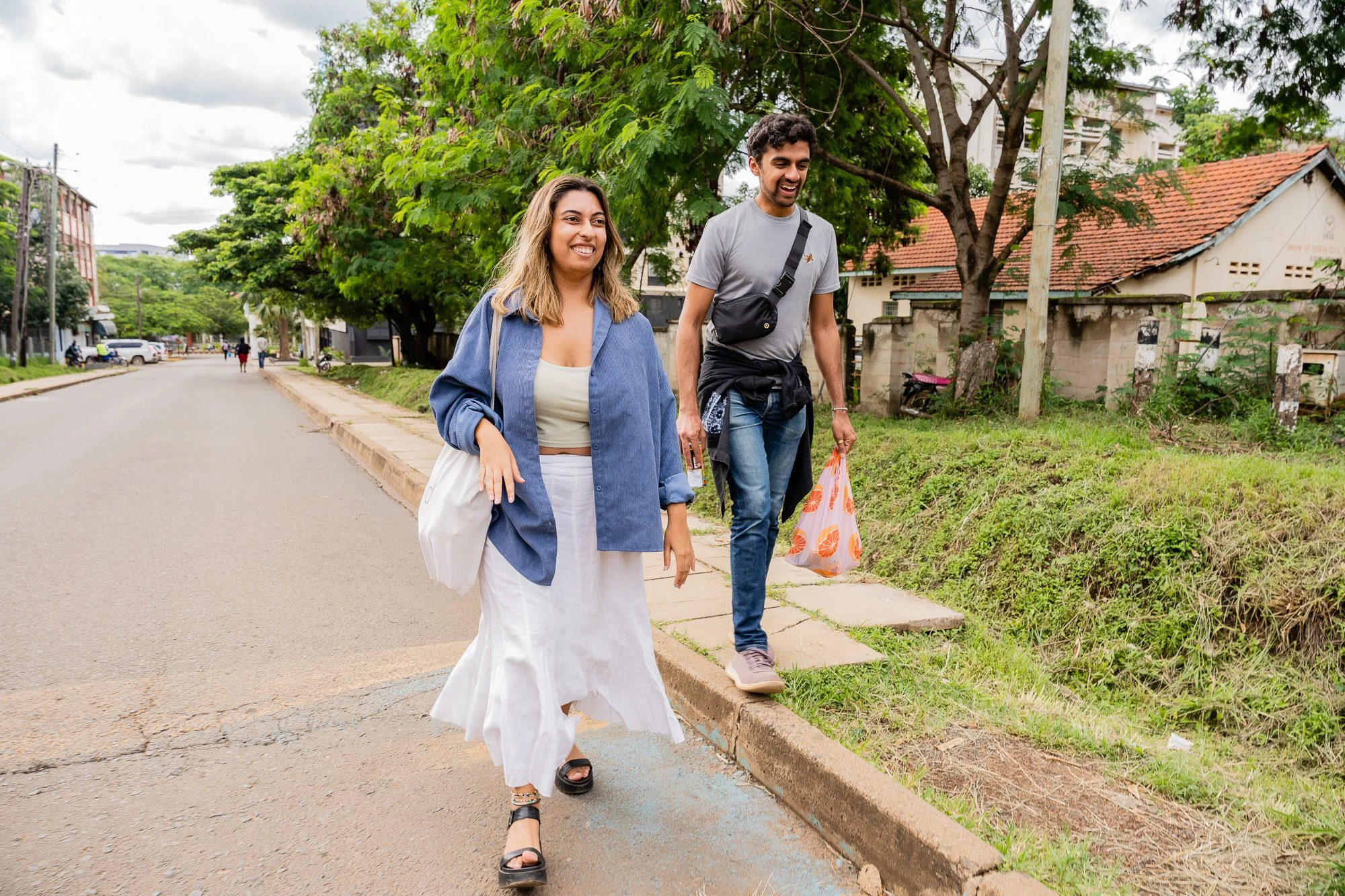 AKFC International Youth Fellowship fellow walking with a friend outdoors in Kisumu, Kenya.