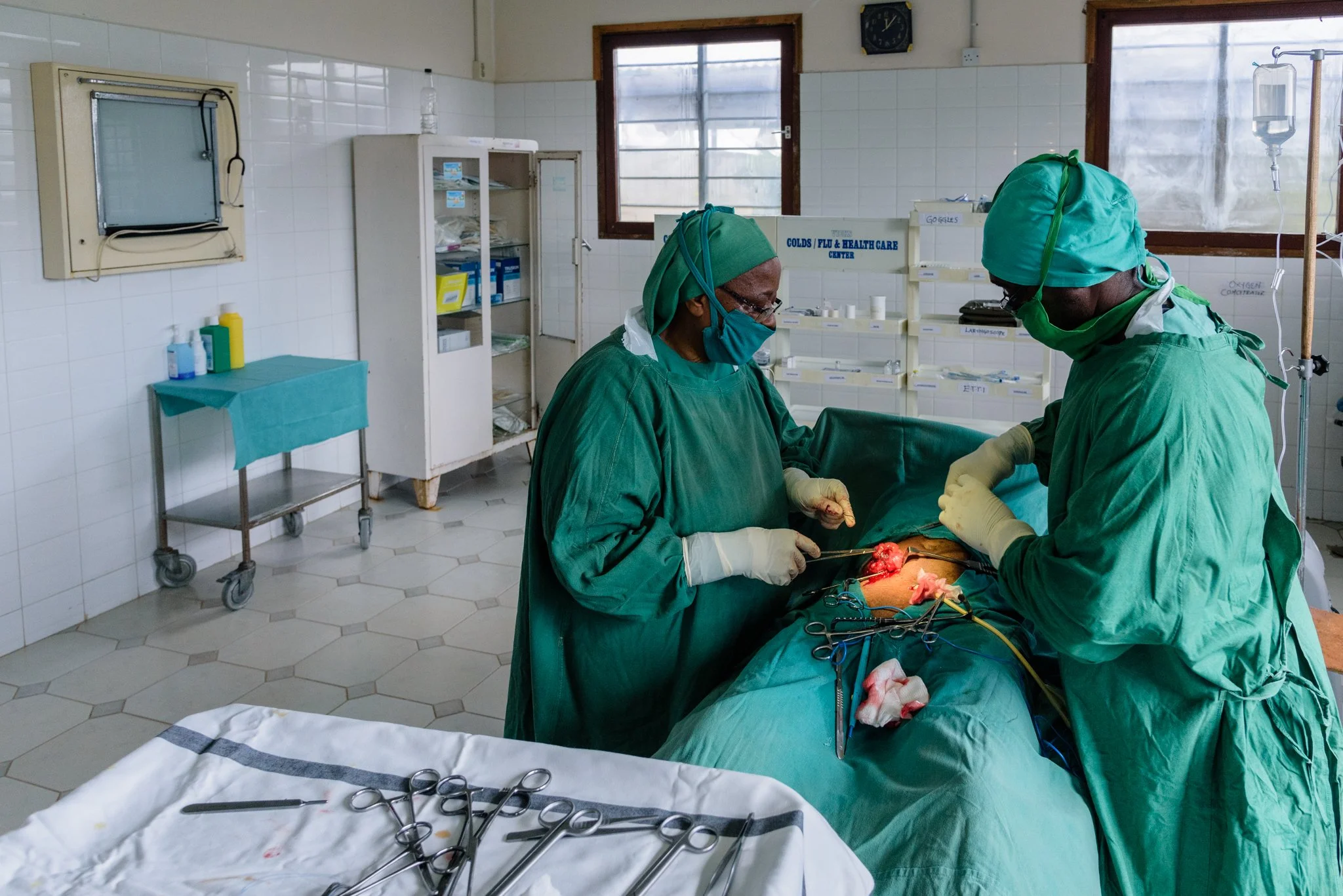 Medical professionals performing surgery inside an operating room at St. Joseph Health Centre in Kwamndolwa, operated by the Usambara Sisters in Korogwe, Tanga Region, Tanzania.