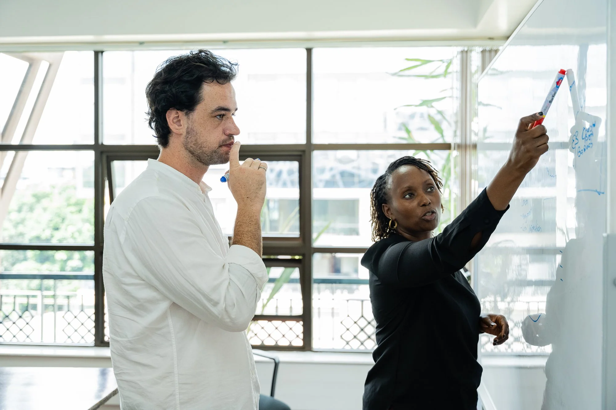 AKFC International Youth Fellowship facilitator and participant collaborating during an interactive learning session in Nairobi, Kenya.