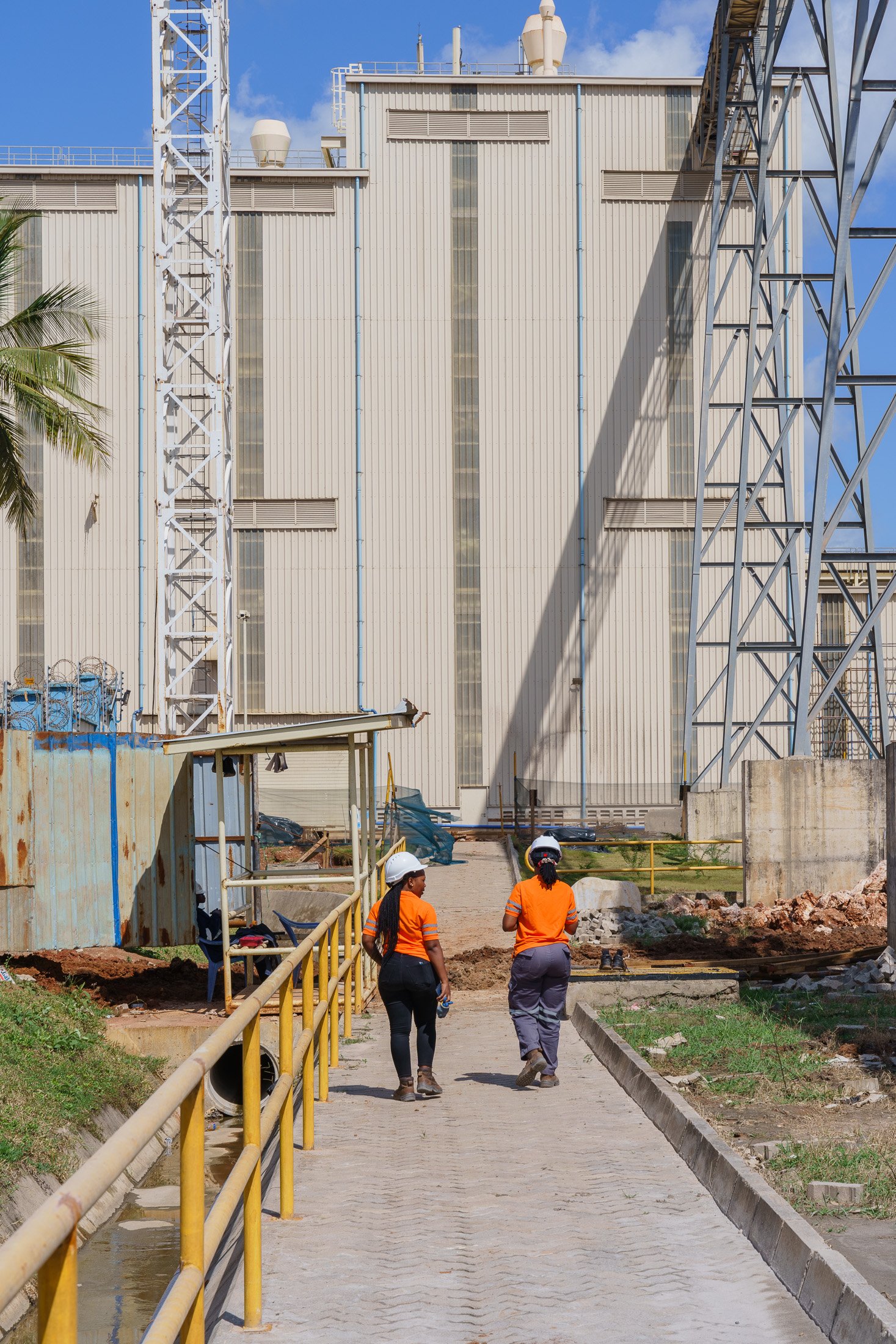 Industrial infrastructure with workers walking through a production site in Mkuranga