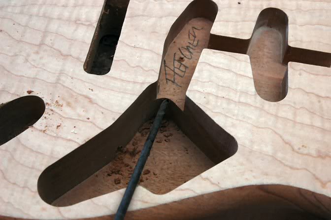 I might point out, in those shots you can really see how very little of the veneer needs to be closely matched for the book matched look. Most is covered by the Pickguard, so unless you’re going for a No PG look, don’t go crazy matching what is going to be routed away. ... Now is a good time to drill the wiring channels.