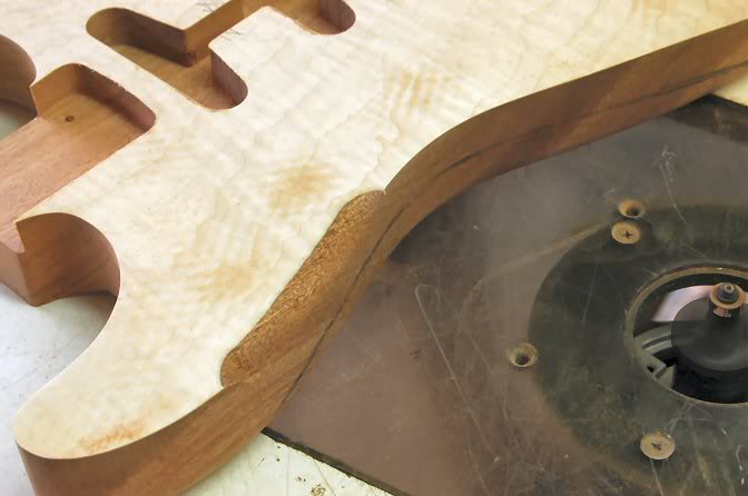 Now on to the body’s round-over. While over the years Strats have been done with many different radii, ½ is the typically accepted norm for the vintage guitars. Some argue that up to 5/8th was used, but personally I feel that would have come as a result of sharpening and re-sharpening the ½” round-over bits. Each time you sharpen one, it gets a tad larger. As you go around, remember the arm contour, you must be careful not to go so far that the tracking bearing looses contact with the body.