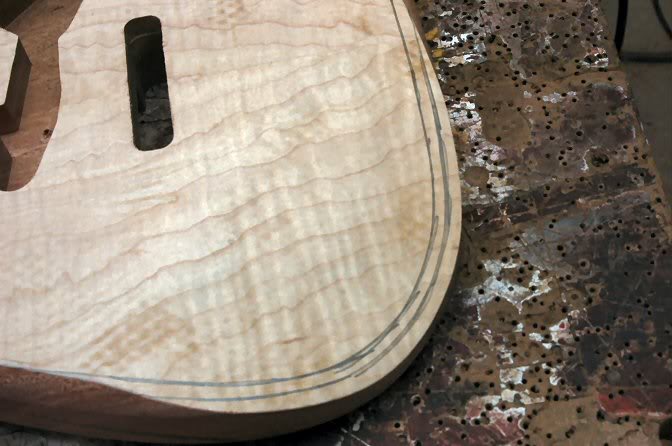  Now, I move on to the fun part. I mark the body to give me some idea where the round over should roll into the flat top of the body. And using a sanding block, I work down to the line. Now this may look daunting, but it’s not. It goes quite fast and