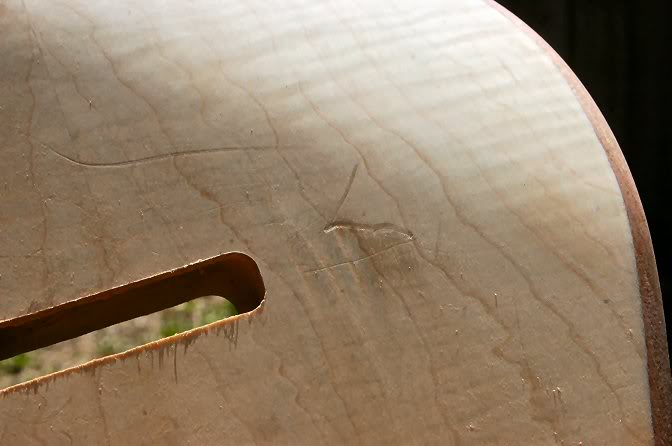 Check it closely in the sunlight, you may find where a piece of wood may have been on the work table and left a calling card.
