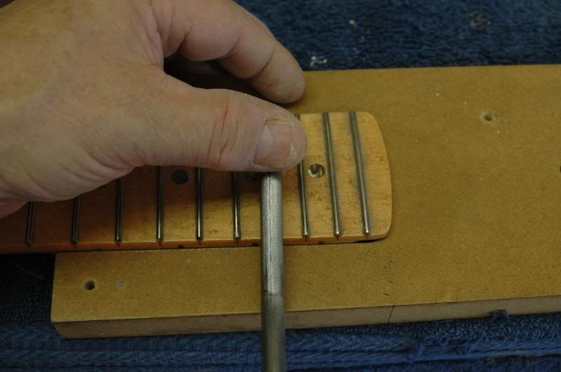  Once the frets are level, let’s crown ‘em. A crowning file is one tool you cannot make, ya cannot find something else and make do, you gotta go buy one, so do it.&nbsp;Watching the marks left by the sandpaper on the leveling tool, crown the frets. R