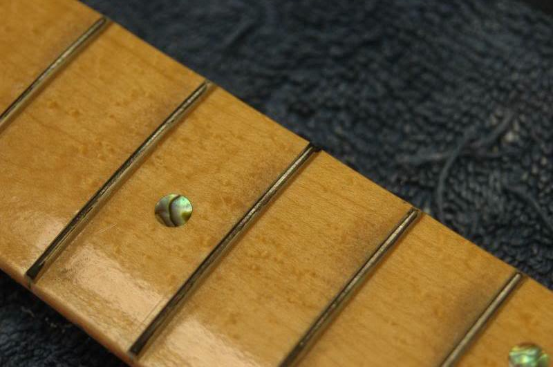  Now using your fret leveling tool and&nbsp;begin scrubbing the frets. I use relatively short circular strokes allowing the tool to roll with the fingerboard radius. You will see the tops of the frets being exposed. 