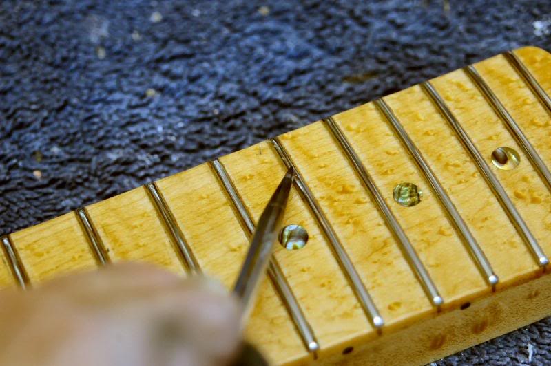  After the frets are polished, I’ll examine each closely and, using my scraper, remove any lacquer, that I may have missed. Then re-polish those frets. 