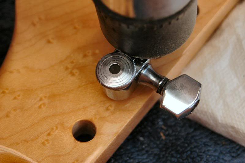  Once the holes are clear, I insert a key and give it a light tap to make an impression where the pin goes. 
