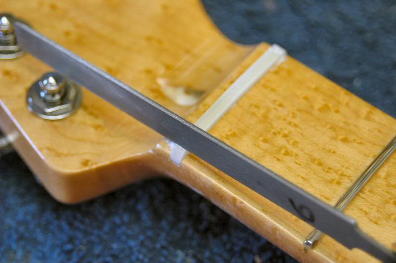  Now I take a nut slotting file and rough in the 1st and 6th string slots. 