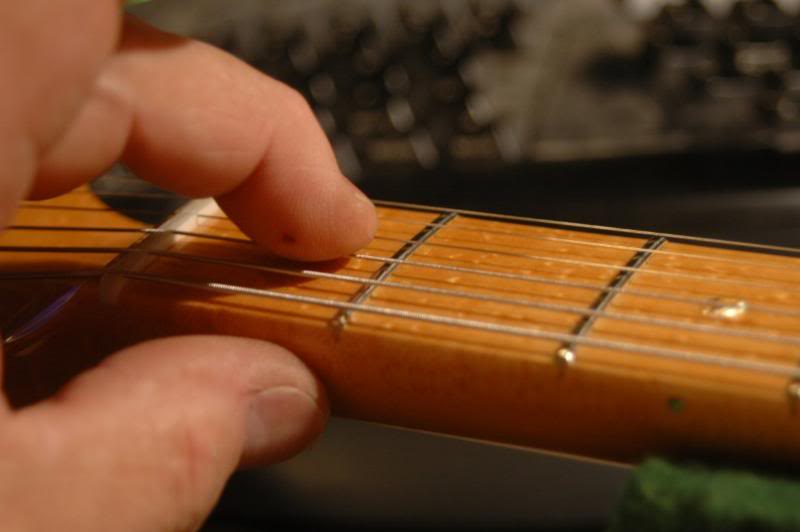  Since I may have raised several strings, I will recheck the height at the first fret and re cut the slots as necessary. Remember the correct height at the first fret is the same as the height at the second fret when the string is fretted at the firs