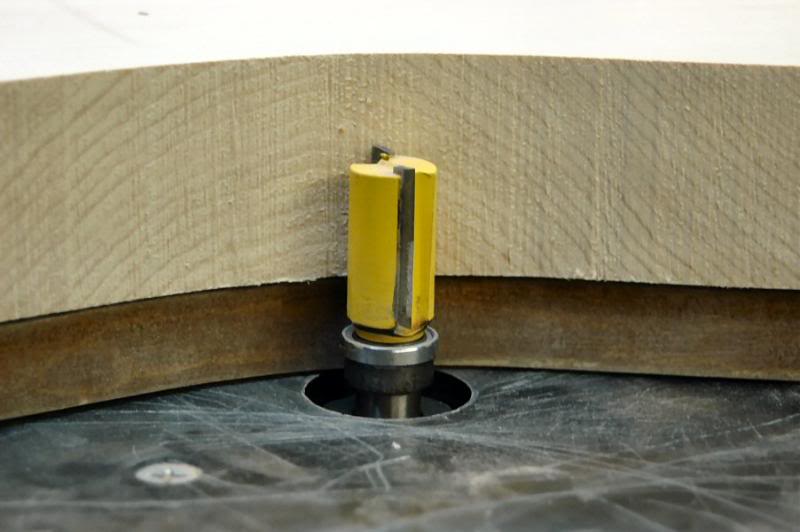  Adjust the Router bit, in this case in a router table, so that the bearing is making secure contact with the template and makes a clean cut. 