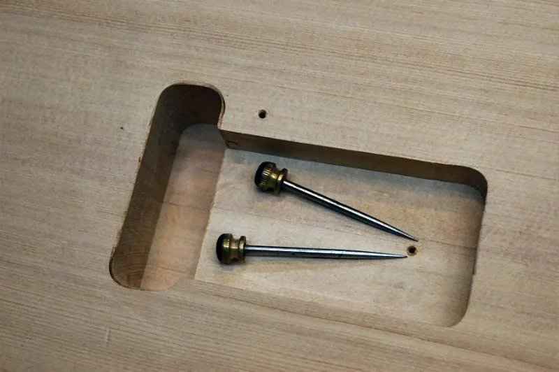 Before we begin the top I want to mark the location of the Tremolo rout, I use two small awls to pierce the remaining 1/8th inch leaving 2 small marks on the top.