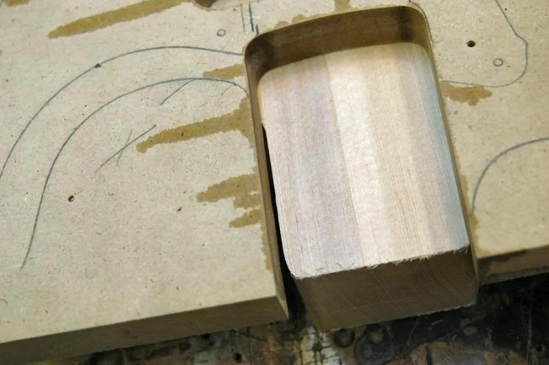 So now I attach, clamp in this case, the top template checking the periphery to be certain it’s in the correct place. Then double checking other “land marks”, like the two marks made with the awls, and the neck pocket relative to the edge of the body. After positioning the template, check the neck pocket to be certain the edges line up… not like this.